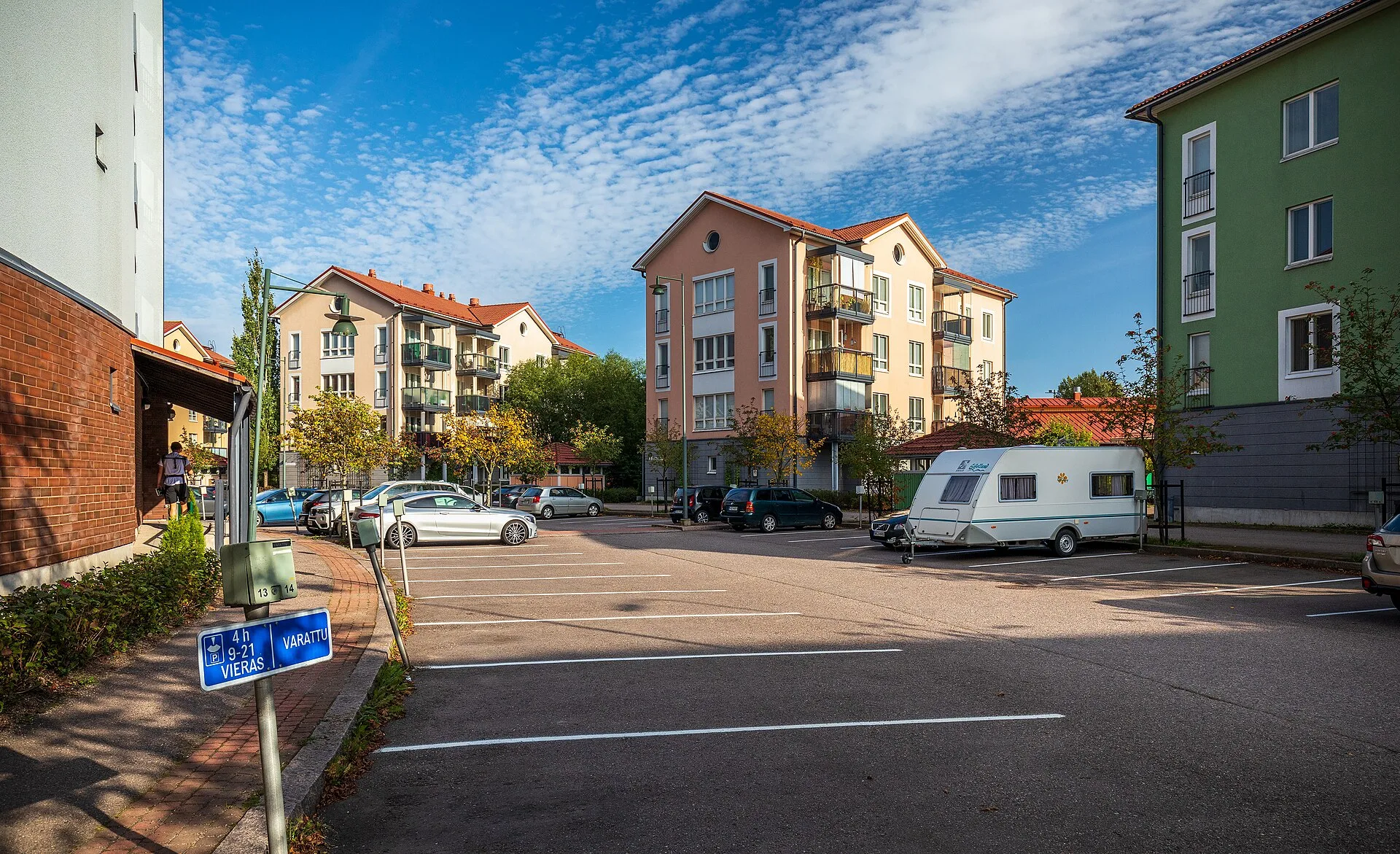 Apartment blocks around the parking lots of Junkkarinkaari in Pakkala, Vantaa, Finland in 2021 September. Apartment EV charger cost boundaries: six labels for every figure