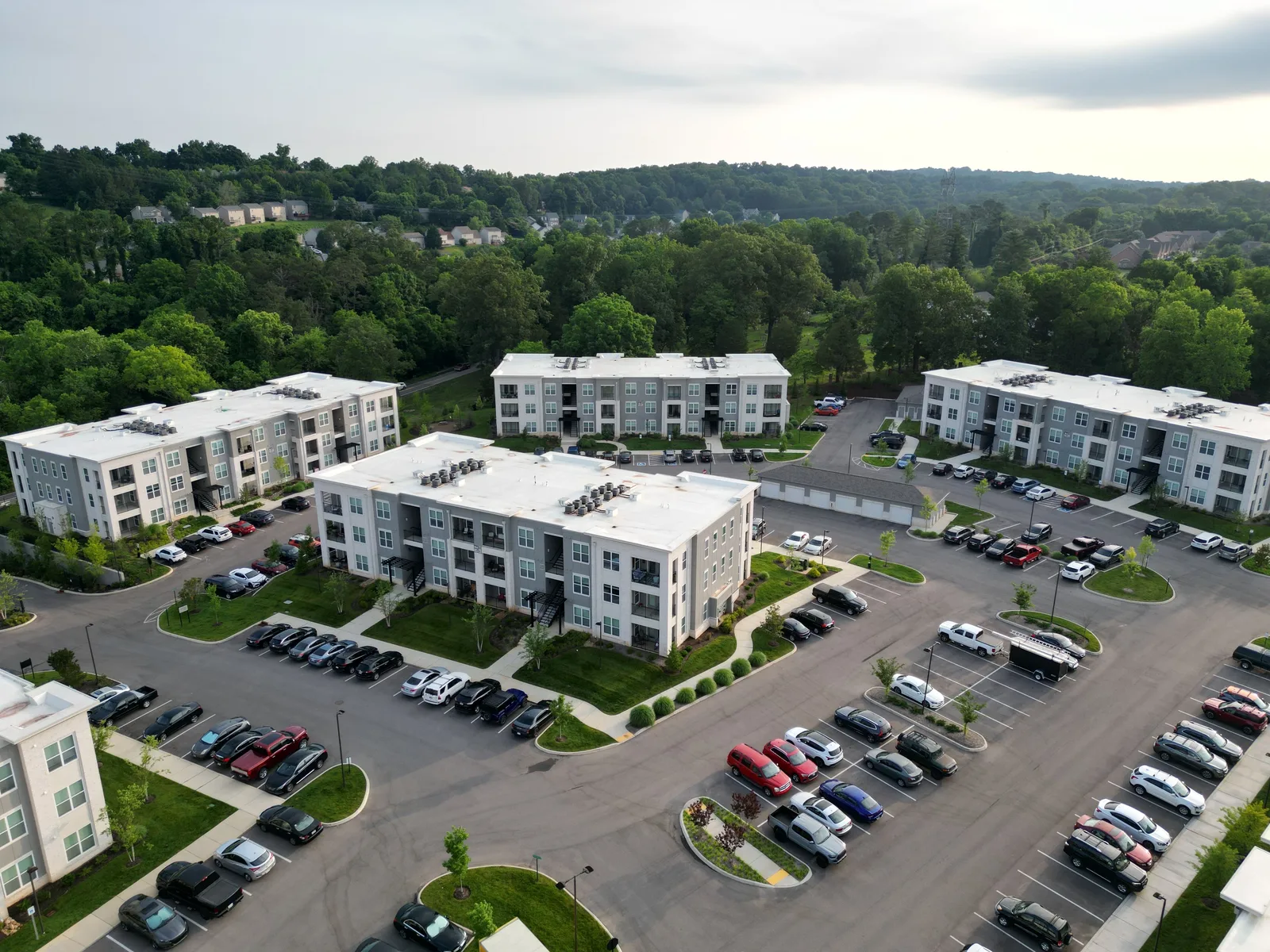 Aerial view of modern apartment complexes with greenery in Knoxville, TN. Apartment EV charger routing register: four labels, sources and review dates