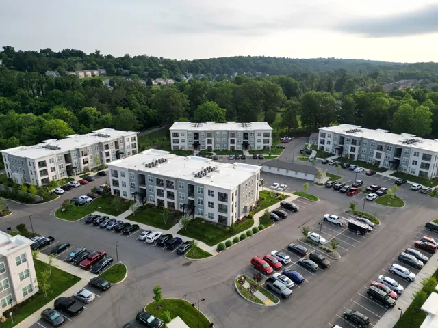 Aerial view of modern apartment complexes with greenery in Knoxville, TN. Apartment EV charger routing register: four labels, sources and review dates