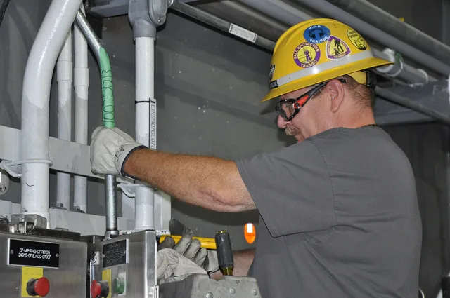A Blue Grass Chemical Agent-Destruction Pilot Plant electrician connects an electrical conduit to a panel in the Munitions Demilitarization Building. The plant’s main processing building houses the equipment and systems to disassemble the munitions and remove and neutralize the energetics and chemic. How to plan a future-ready EV charger installation setup